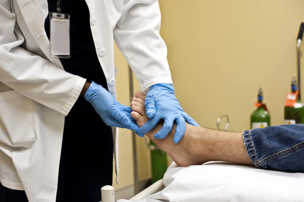 foot doctor treating ankle pain