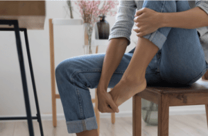 woman touch massage foot suffer from uncomfortable tired unwell feet
